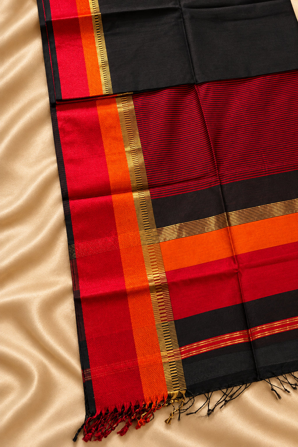 Black Maheshwari saree with red , orange and gold zari border